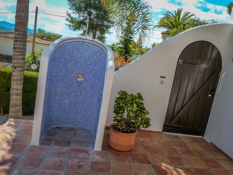 Poolside shower with blue tiles